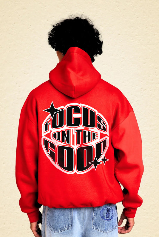 Person wearing a red hoodie with 'Focus on the Good' text