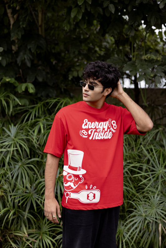 Person wearing a red t-shirt with a graphic design and text.