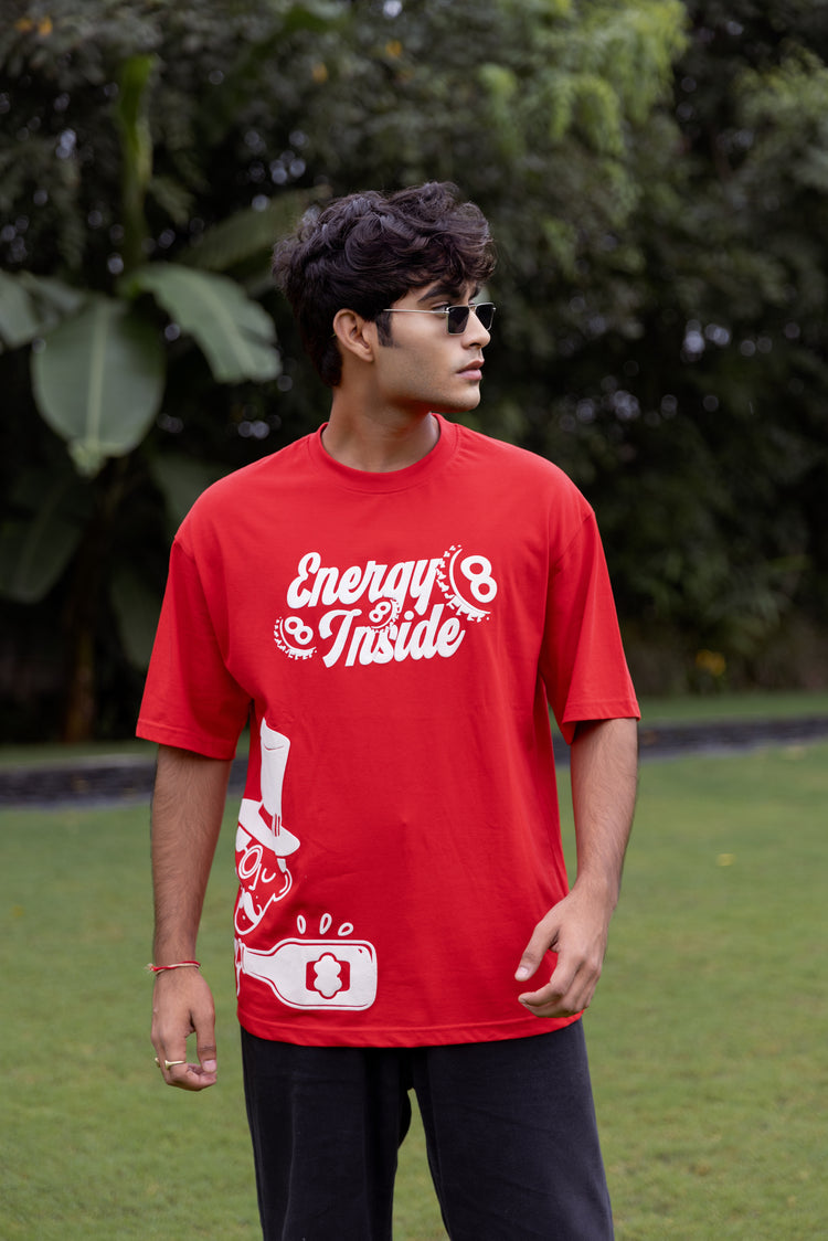 Person wearing a red t-shirt with text and graphics outdoors