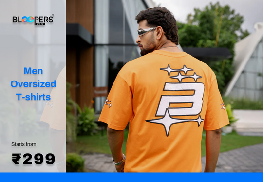 Man wearing an orange oversized t-shirt with promotional text