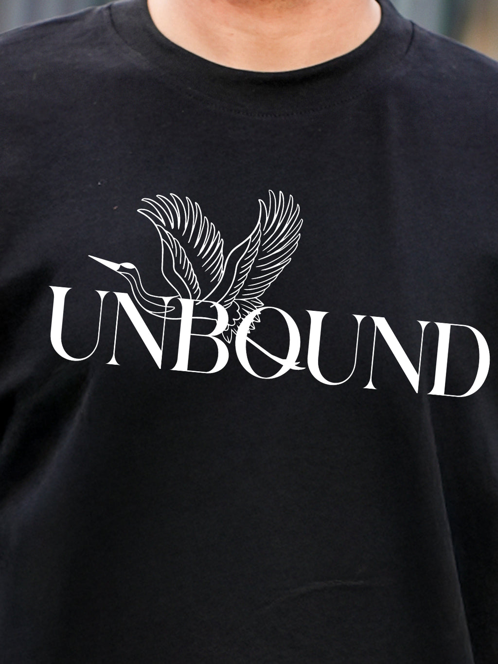 Black t-shirt with 'UNBOUND' and a bird design 