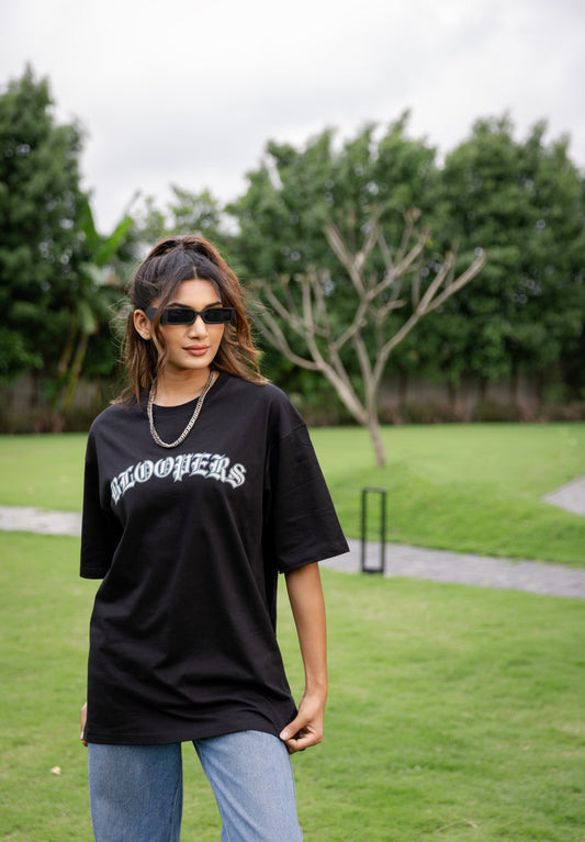 Woman wearing a black t-shirt with 'Bloomers' text 