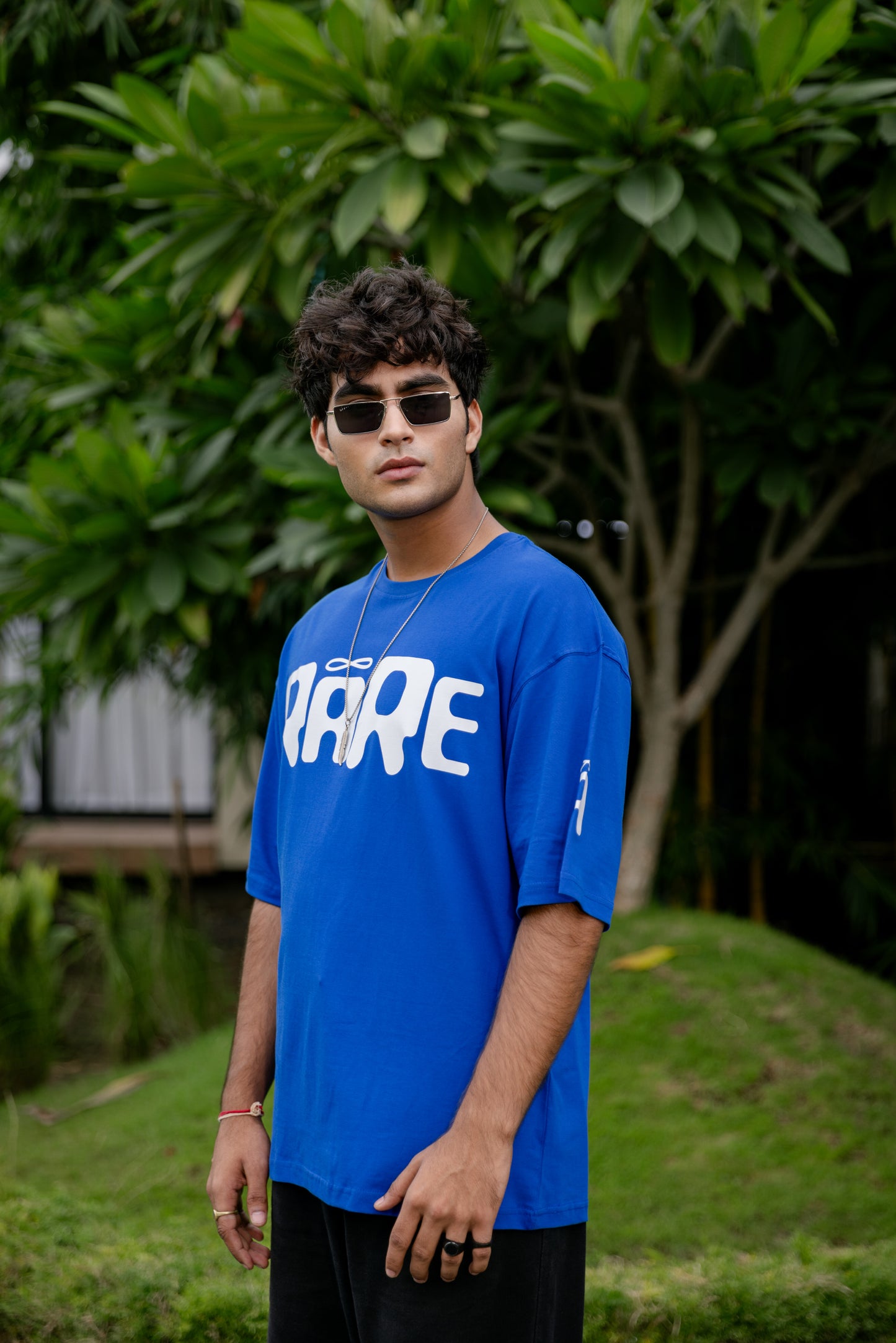 Man wearing a blue t-shirt with white text 