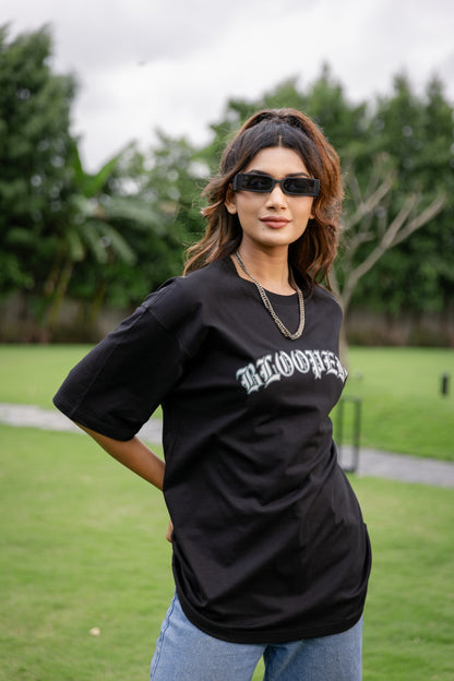 Woman wearing a black oversized t-shirt with text