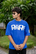 Person wearing a blue 'RARE' t-shirt 