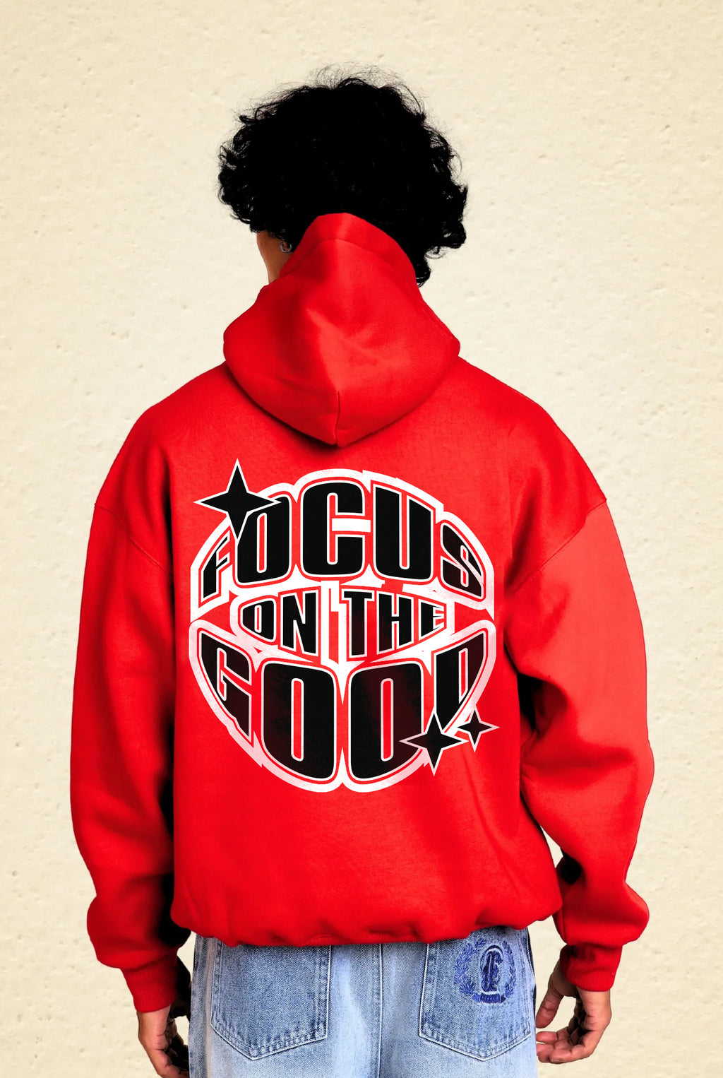 Person wearing a red hoodie with 'Focus on the Good' text 