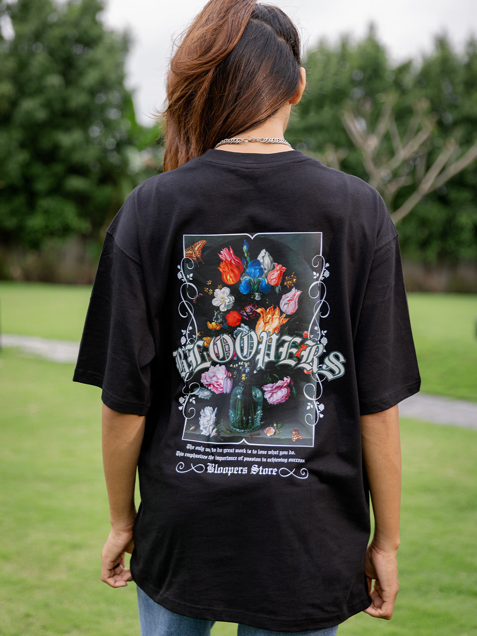 Girl wearing a black t-shirt with a colorful graphic design 