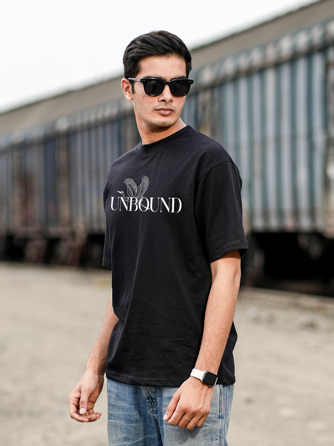 Man wearing a black t-shirt with 'UNBOUND' text
