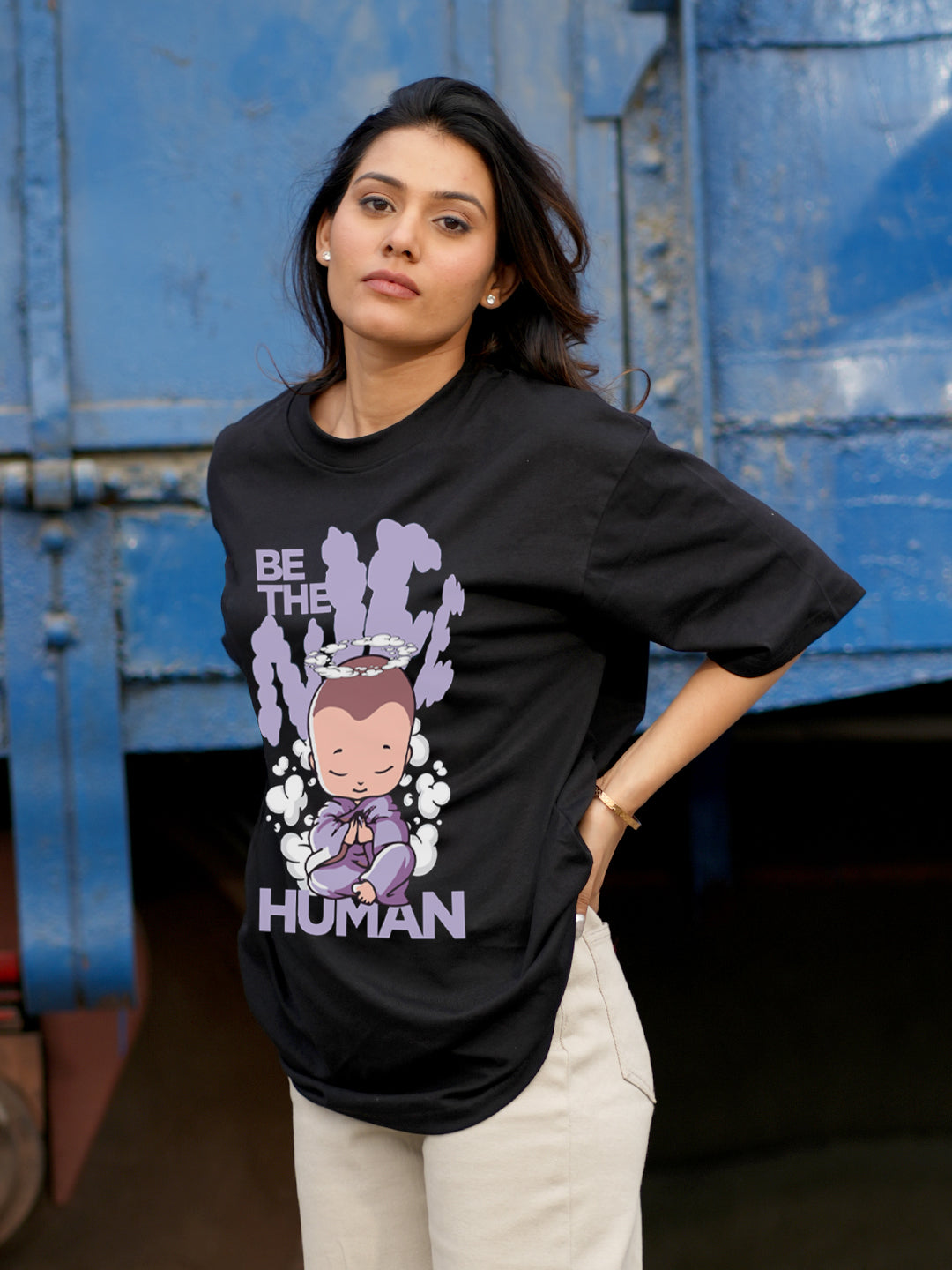 Woman wearing a black t-shirt with a graphic design 