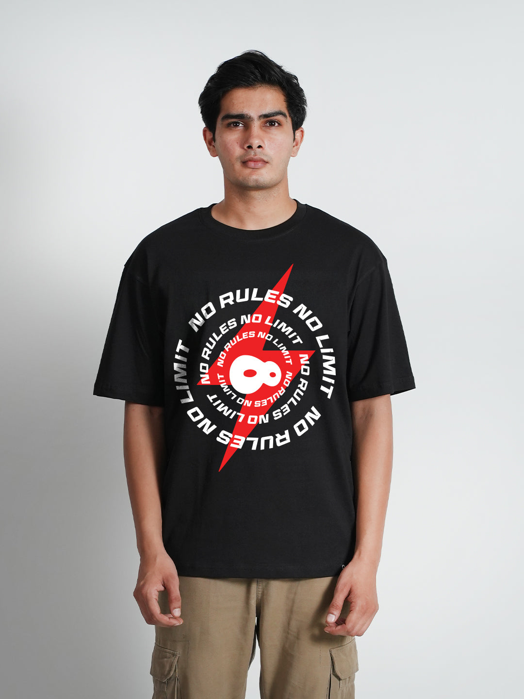 A man wearing a black oversized t-shirt 