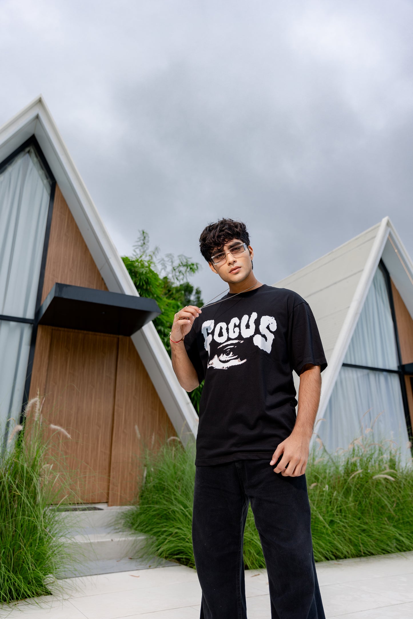 Person wearing a black t-shirt with 'FOCUS' text.