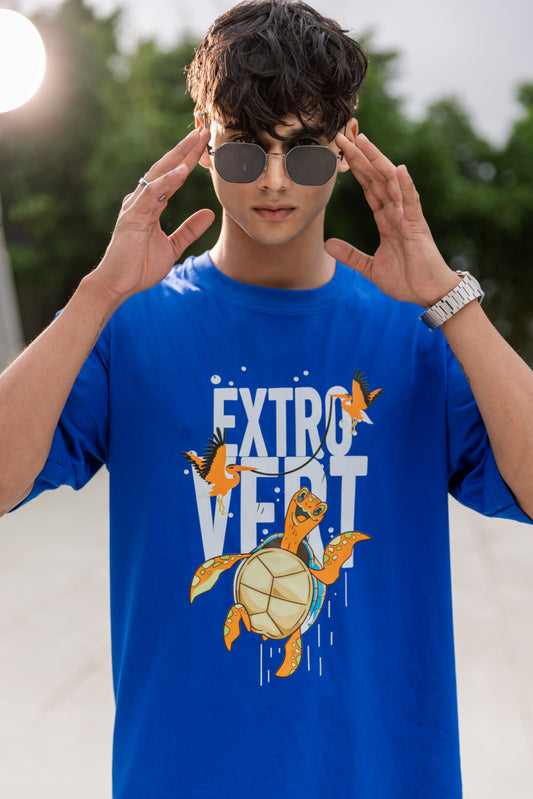Person wearing a blue t-shirt with a turtle graphic and 'EXTROVERT' text.
