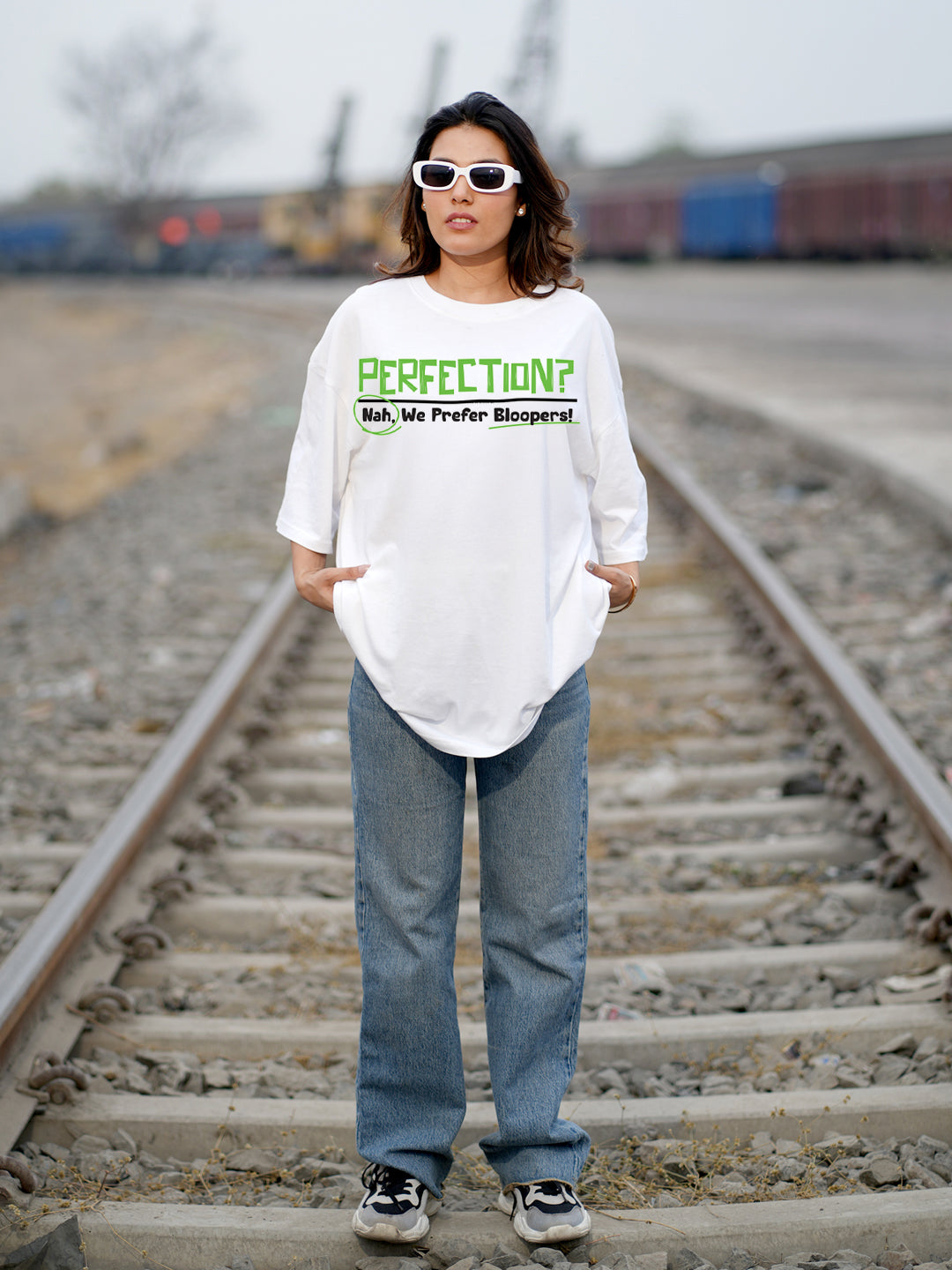 Person wearing a white t-shirt with text on it