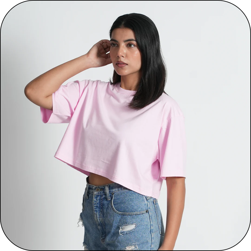 Girl wearing a pink crop top and blue jeans 