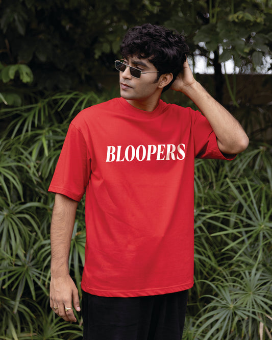 Person wearing a red 'BLOOPERS' t-shirt