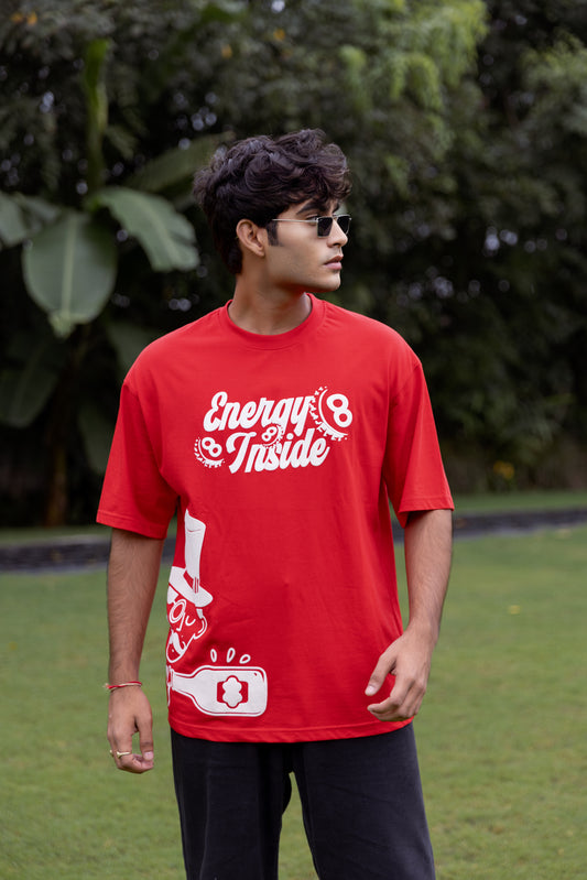 Person wearing a red t-shirt with text and graphics outdoors